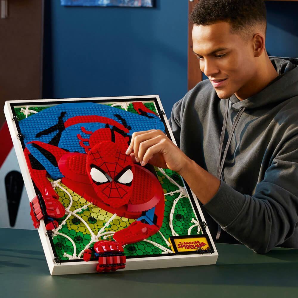 Man shown with the LEGO® Art The Amazing Spider-Man 31209 Building Kit (2,099 Pieces)