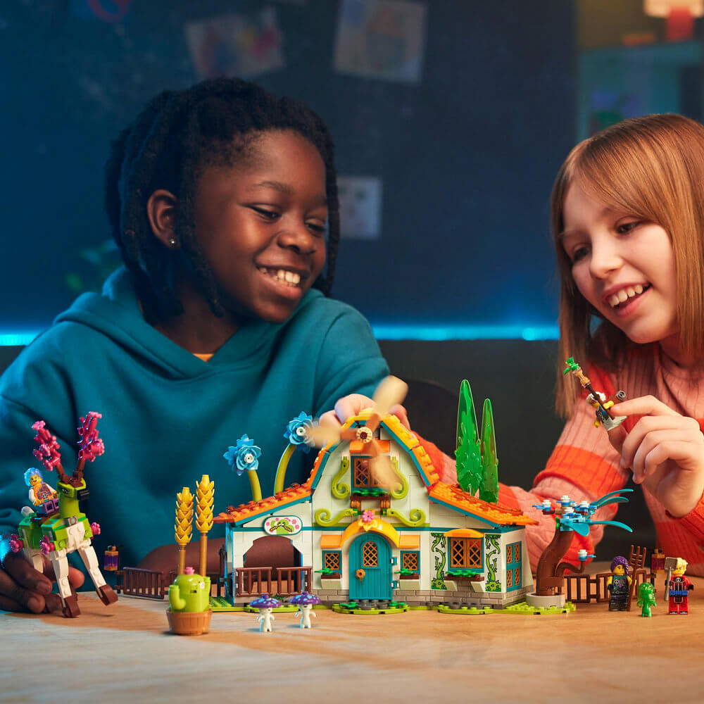 Two kids playing with the LEGO® DREAMZzz™ Stable of Dream Creatures 71459 Building Toy Set (681 Pieces)