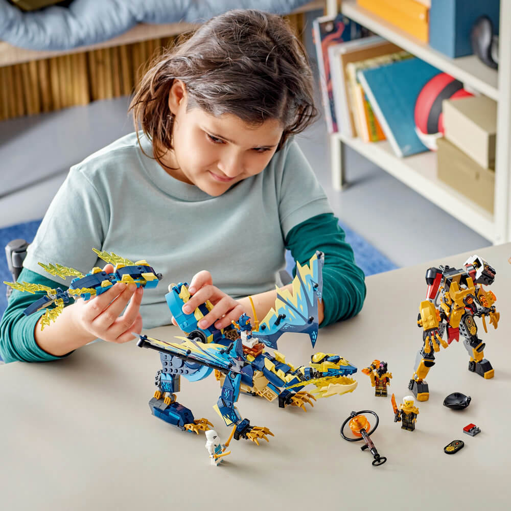 Child building the LEGO® NINJAGO® Elemental Dragon vs. The Empress Mech 71796 Building Toy Set (1,038 Pieces)