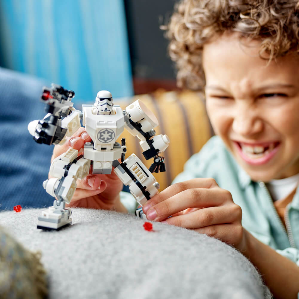 Kid playing with the LEGO® Star Wars™ Stormtrooper™ Mech 75370 Building Toy Set (138 Pieces)