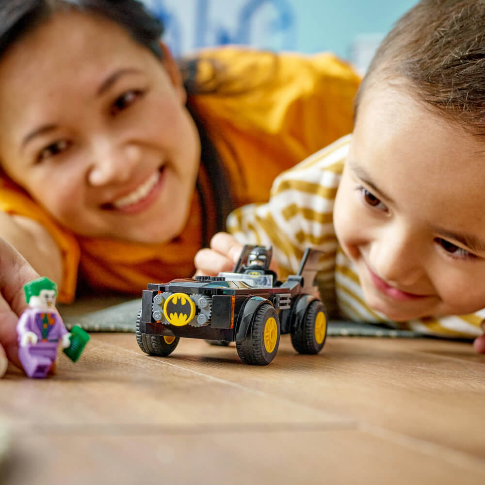 Child and adult playing with the LEGO® DC Batmobile™ Pursuit: Batman™ vs. The Joker™ 76264 Building Toy Set (54 Pcs)