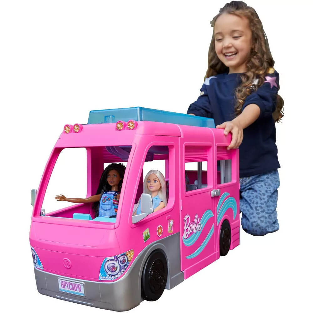 Girl playing with the Barbie Dream Camper Vehicle Playset
