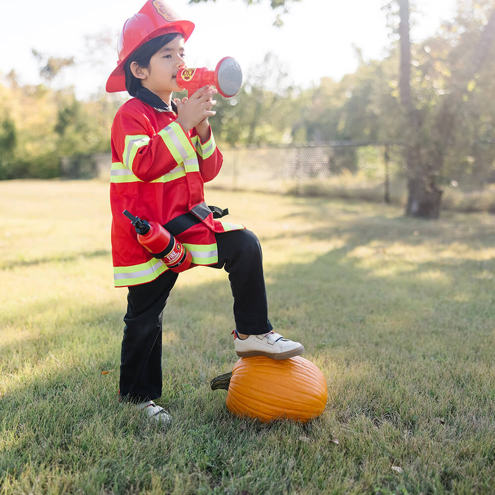 Child dressed in the Melissa and Doug Fire Chief Role Play Costume Set