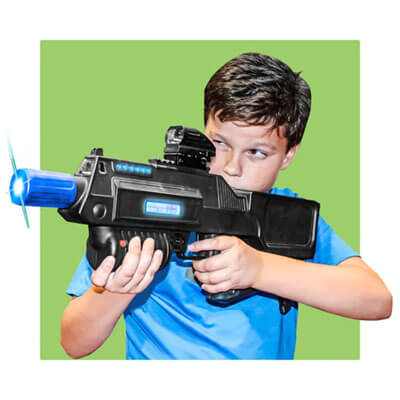 Boy playing laser tag and holding a tagger.