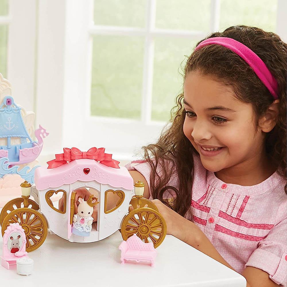 Girl playing with the Calico Critters Royal Carriage Playset