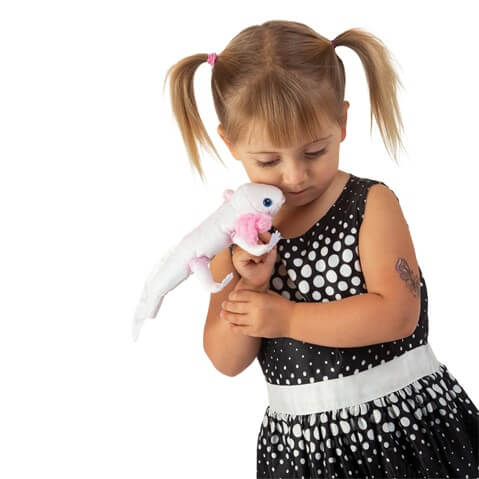 Girl in a black dress is playing with the Folkmanis Axolotl Finger Puppet.