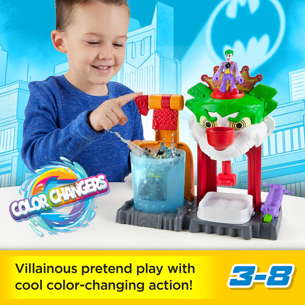 Boy playing with the Imaginext DC Super Friends Color Changers The Joker Funhouse Playset