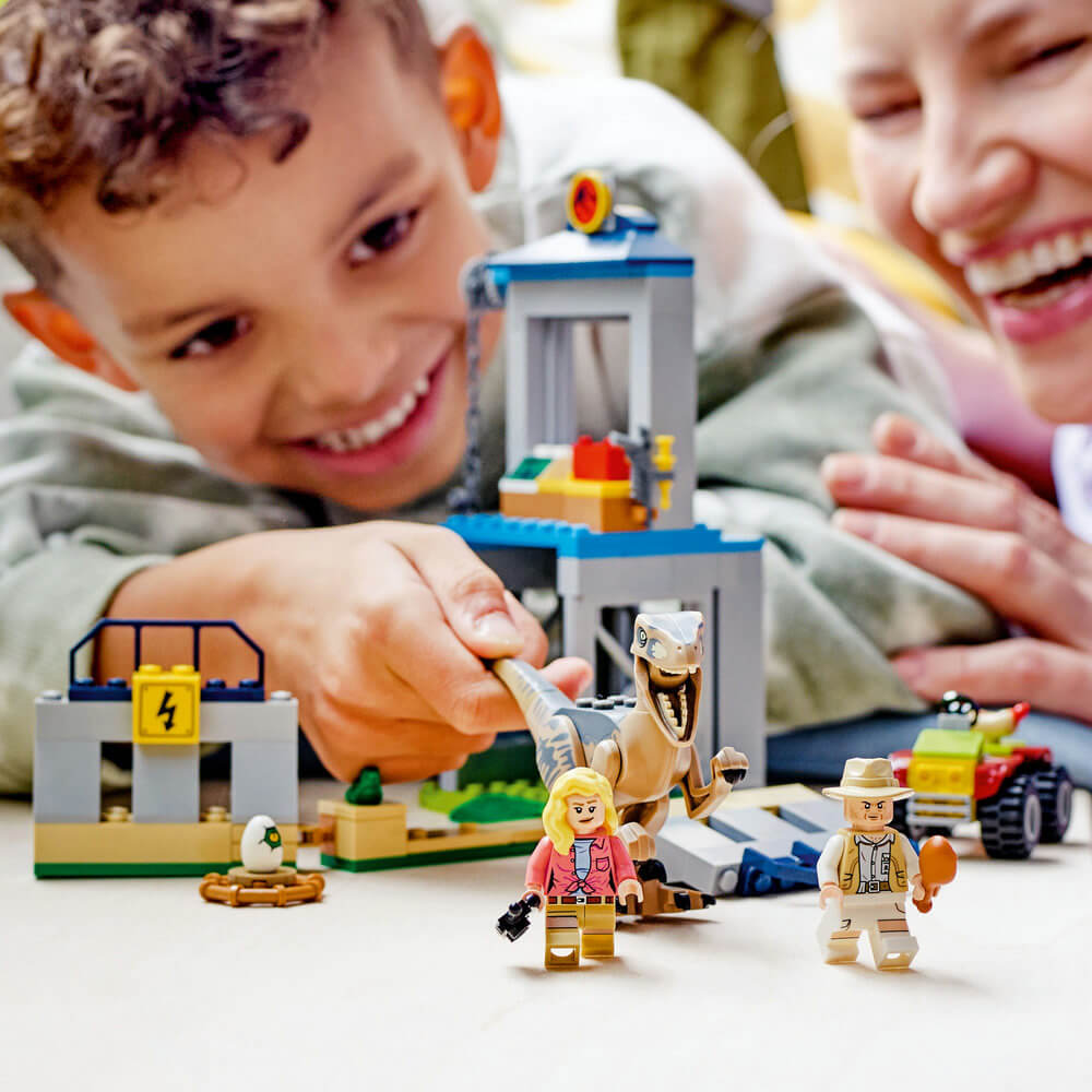 Boy and mom playing with the LEGO® Jurassic World Velociraptor Escape 137 Piece Building Set