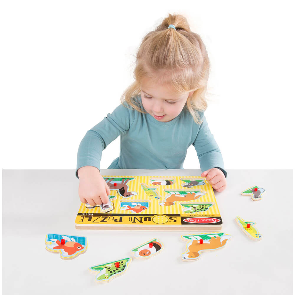 Little girl playing with the Melissa and Doug Pets 8 Piece Sound Puzzle