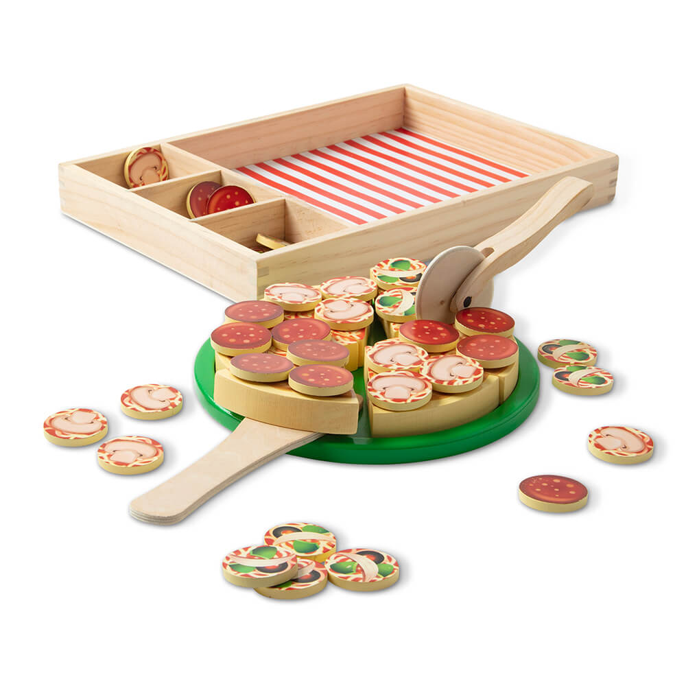 Pieces of the Melissa and Doug Pizza Party Wooden Food Play Set removed and made into a pizza