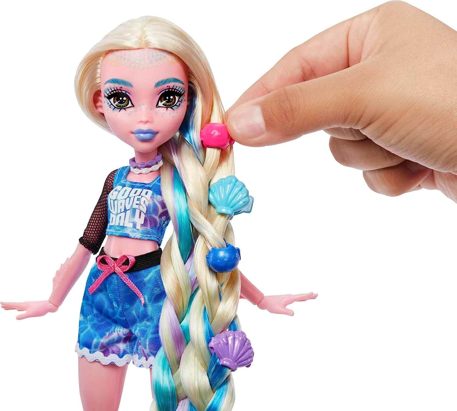 Doll shown with hand putting beads in dolls hair from the Monster High Lagoona Blue Spa Day Doll and Accessories