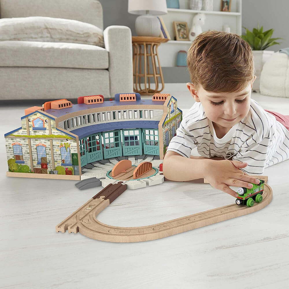 child playing with the Fisher-Price Thomas & Friends Wooden Railway Tidmouth Sheds Starter Train Set