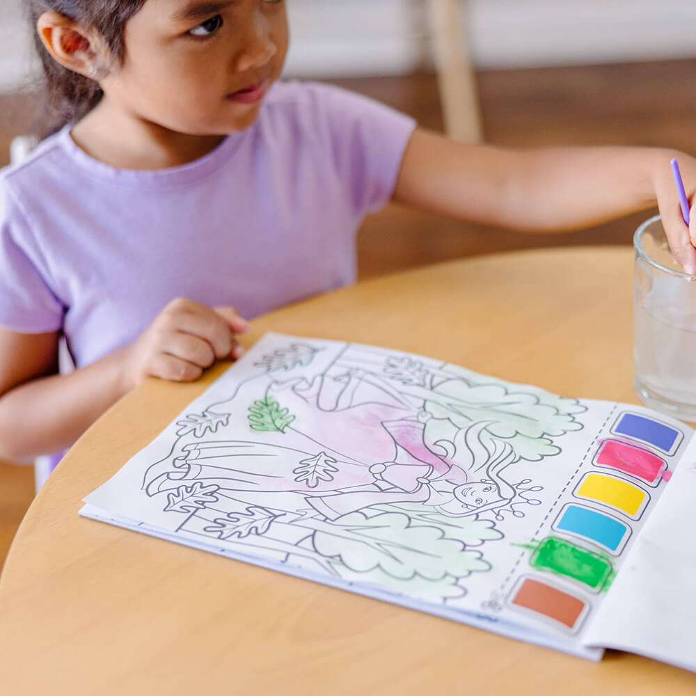 Child rinsing their brush that comes with Melissa and Doug Princess Paint with Water Kids Art Pad
