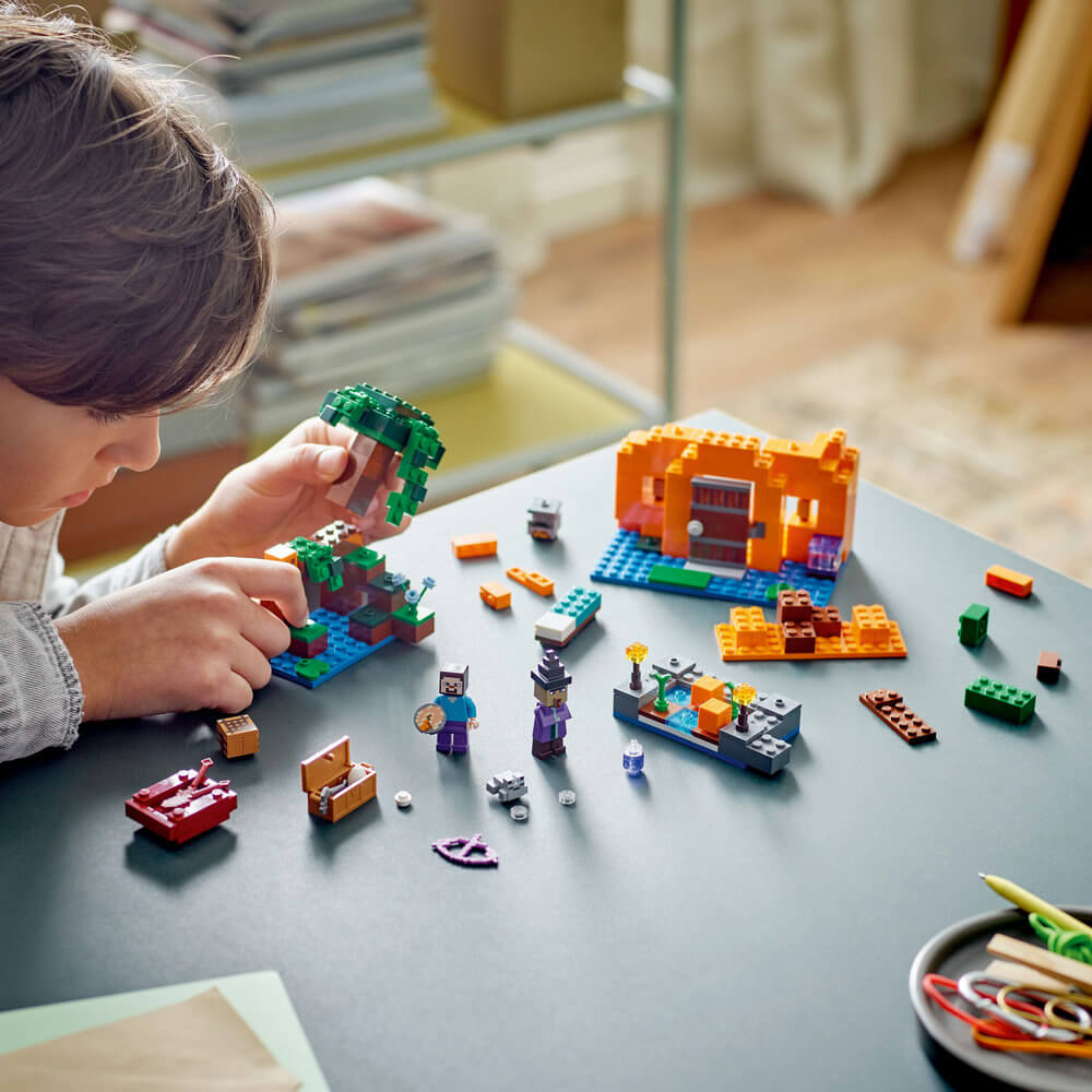 Child shown building the LEGO® Minecraft® The Pumpkin Farm 21248 Building Toy Set (257 Pieces)
