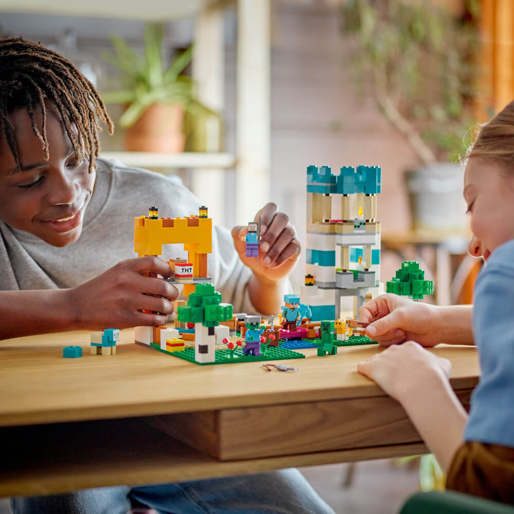 Two people playing with the LEGO® Minecraft® The Crafting Box 4.0 21249 Building Toy Set (605 Pieces)