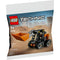 Front of LEGO Technic Skid-Steer Loader polybag set 30710 displays the small construction vehicle with moving bucket in a desert-like setting, includes 52 pieces for ages 7 and up.