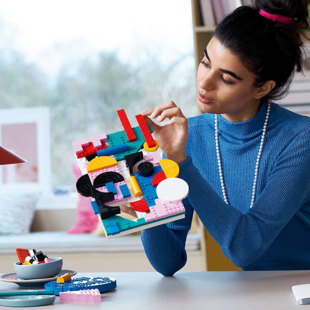 Person shown building the LEGO® Art Modern Art 31210 Building Kit (805 Pieces)