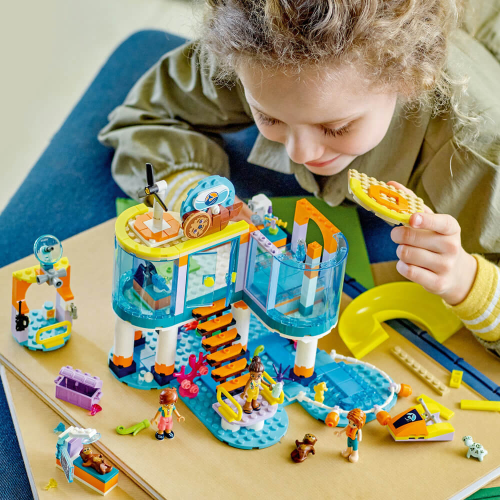 Child building the LEGO® Friends Sea Rescue Center 41736 Building Toy Set (376 Pieces)