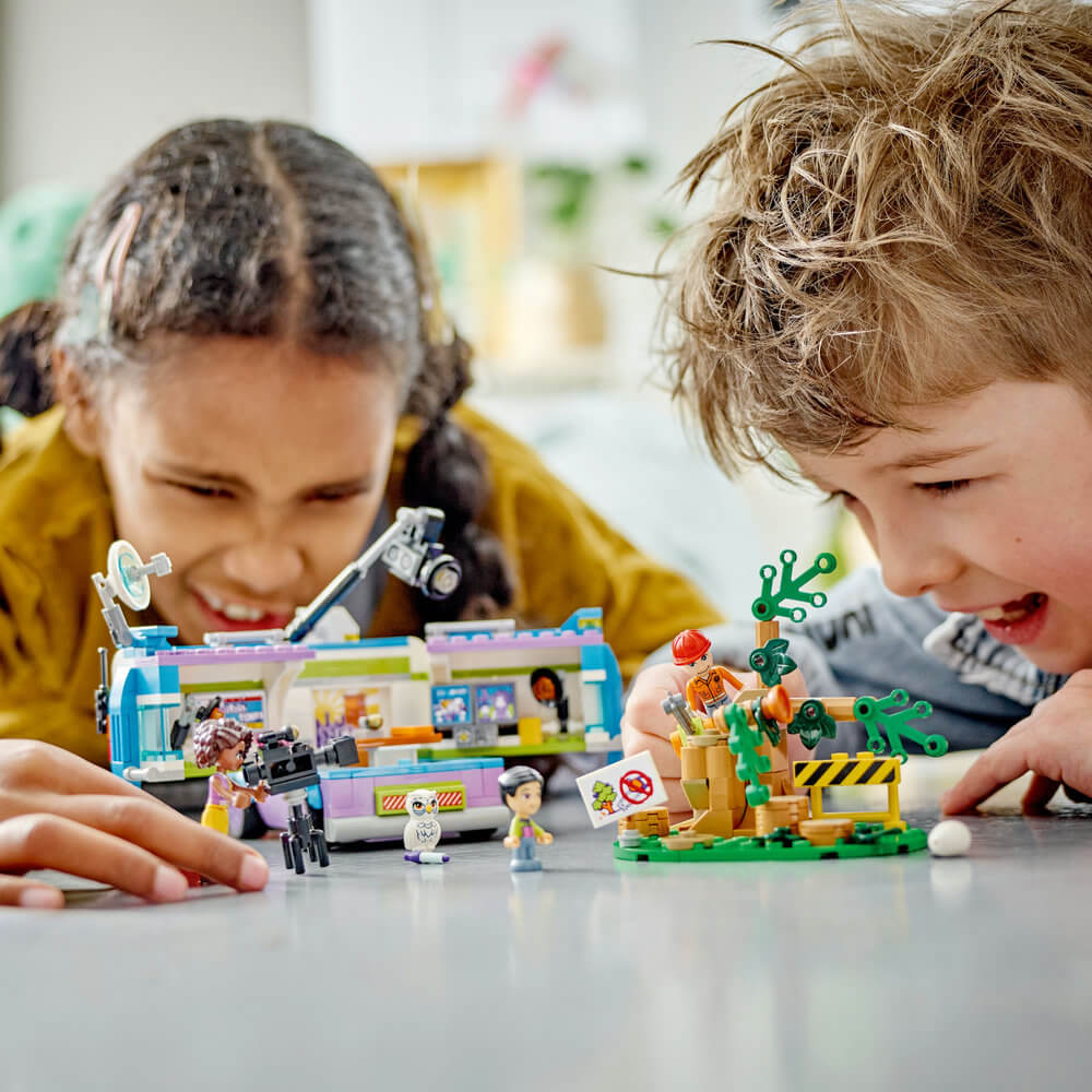 Two kids playing with the LEGO® Friends Newsroom Van 41749 Building Toy Set (446 Pieces)