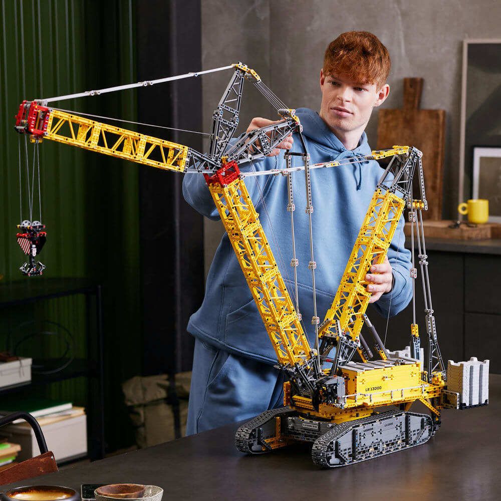 Person playing with the completed LEGO® Technic™ Liebherr Crawler Crane LR 13000 42146 Building Kit (2,883 Pieces)