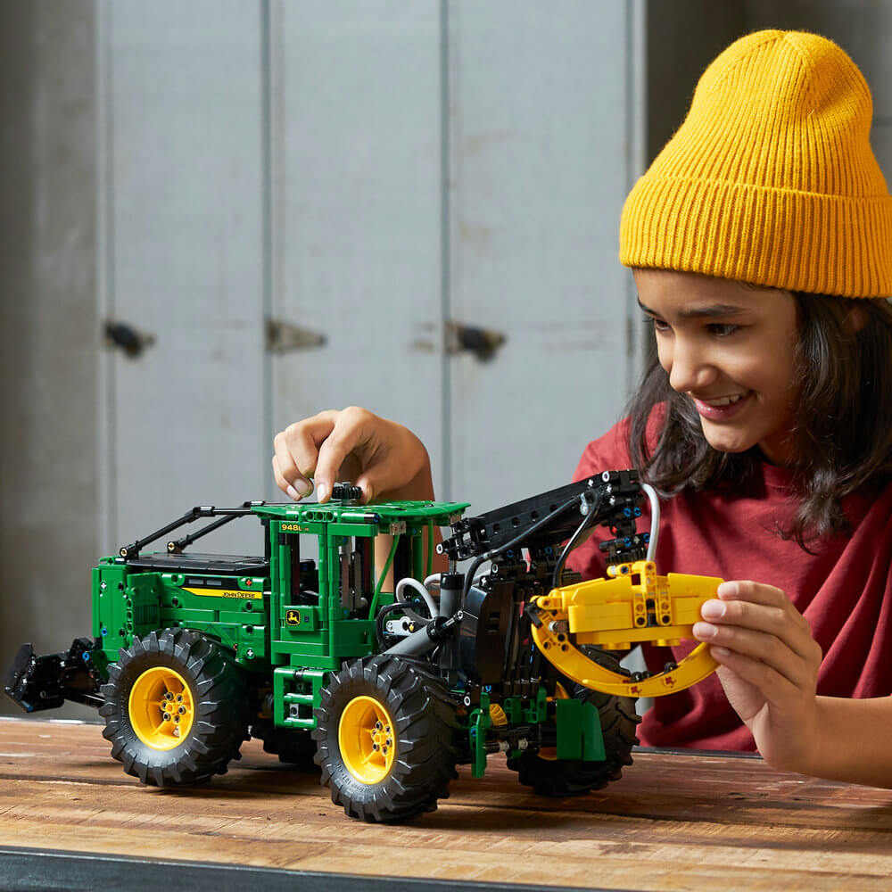 Person playing with the completed LEGO® Technic™ John Deere 948L-II Skidder 42157 Building Toy Set (1,492 Pieces)