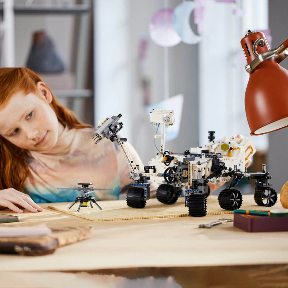 Girl shown looking at the LEGO® Technic™ NASA Mars Rover Perseverance 42158 Building Toy Set (1,132 Pieces) completed set