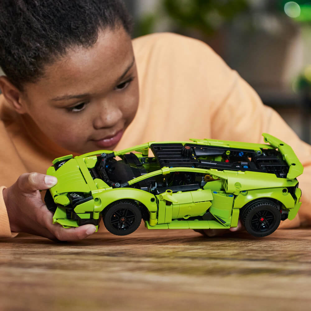Person playing with the built LEGO® Technic™ Lamborghini Huracán Tecnica 42161 Building Toy Set (806 Pieces)