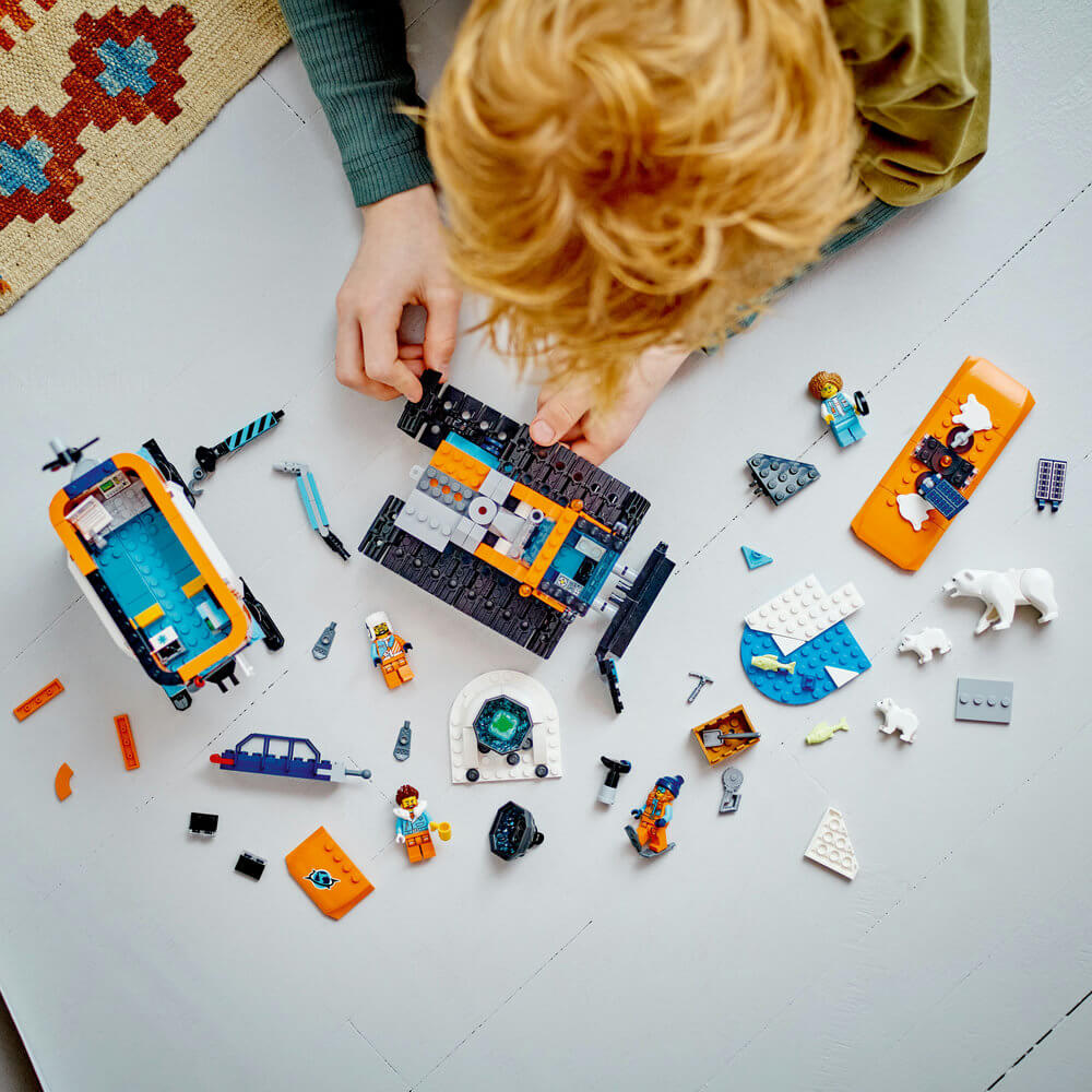 Child building LEGO® City Arctic Explorer Truck and Mobile Lab 60378 Building Toy Set (489 Pieces)
