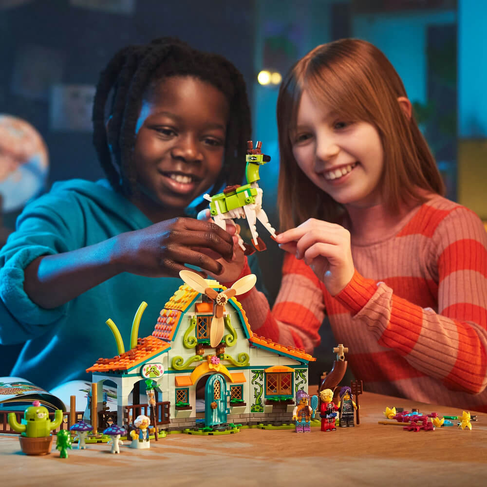 Two children playing and smiling at the LEGO® DREAMZzz™ Stable of Dream Creatures 71459 Building Toy Set (681 Pieces) 