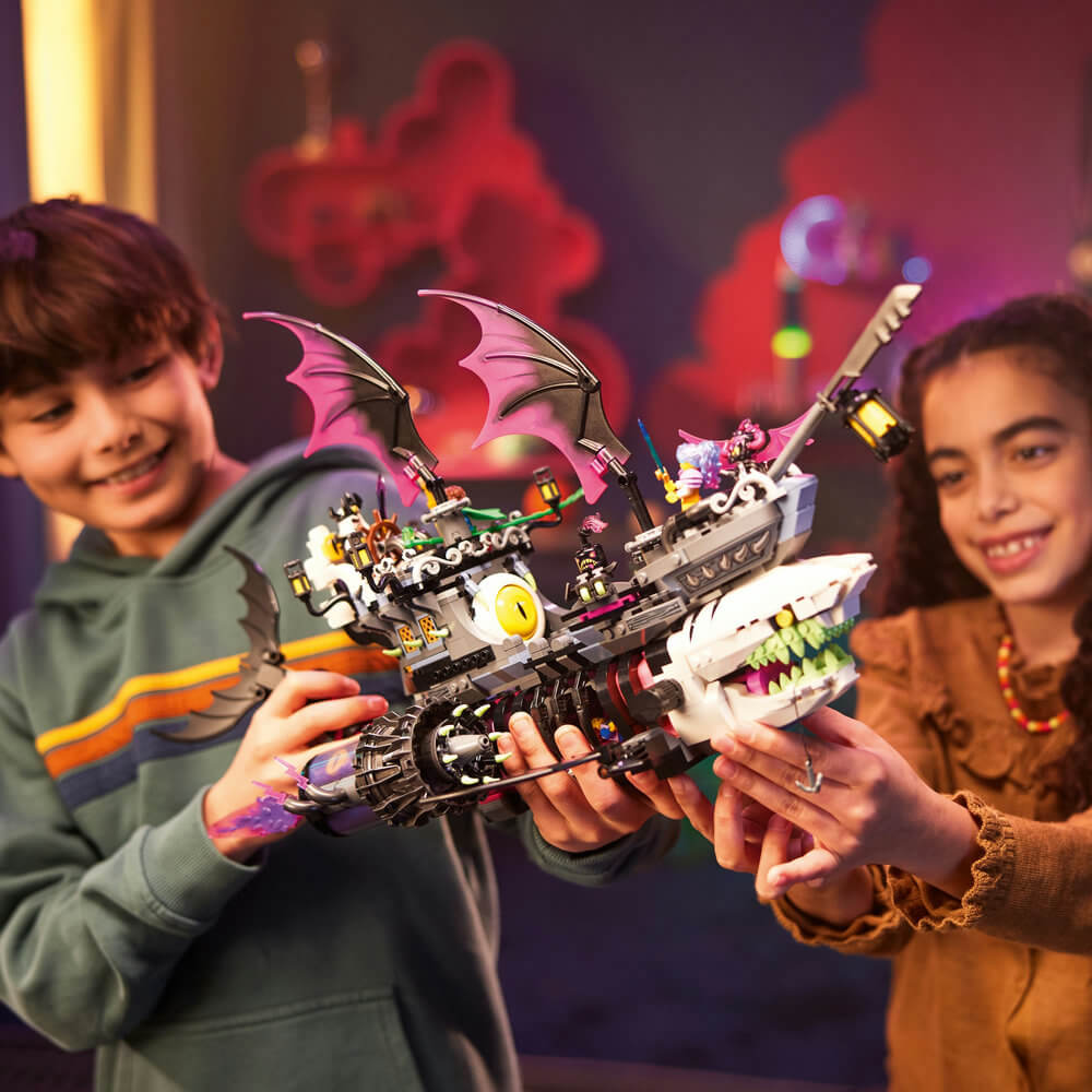 Two kids playing with the LEGO® DREAMZzz™ Nightmare Shark Ship 71469 Building Toy Set (1,389 Pieces)