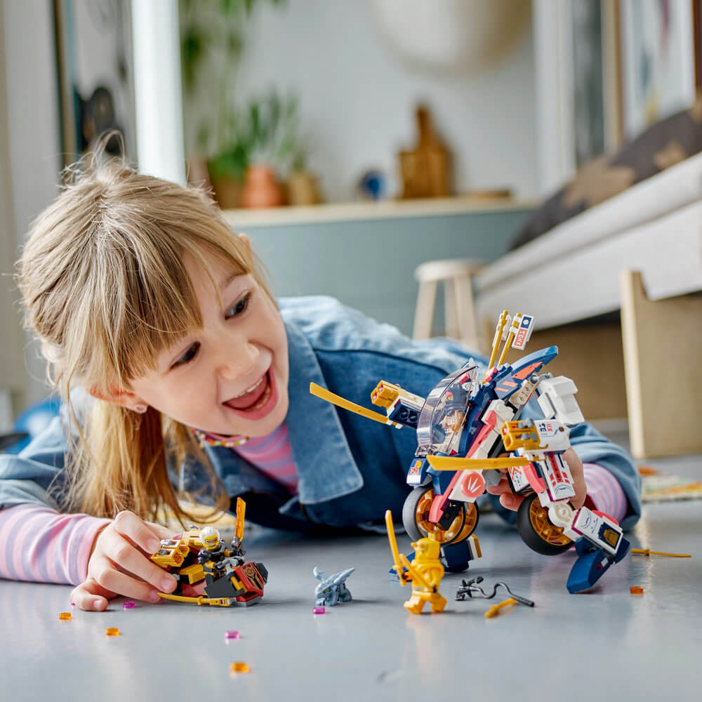Child playing with LEGO® NINJAGO® Sora’s Transforming Mech Bike Racer 71792 Building Toy Set (384 Pcs)
