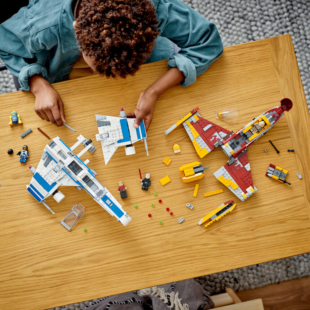 Person shown building the LEGO® Star Wars New Republic E-Wing™ vs. Shin Hati’s Starfighter™ 1056 Piece Building Set (75364)