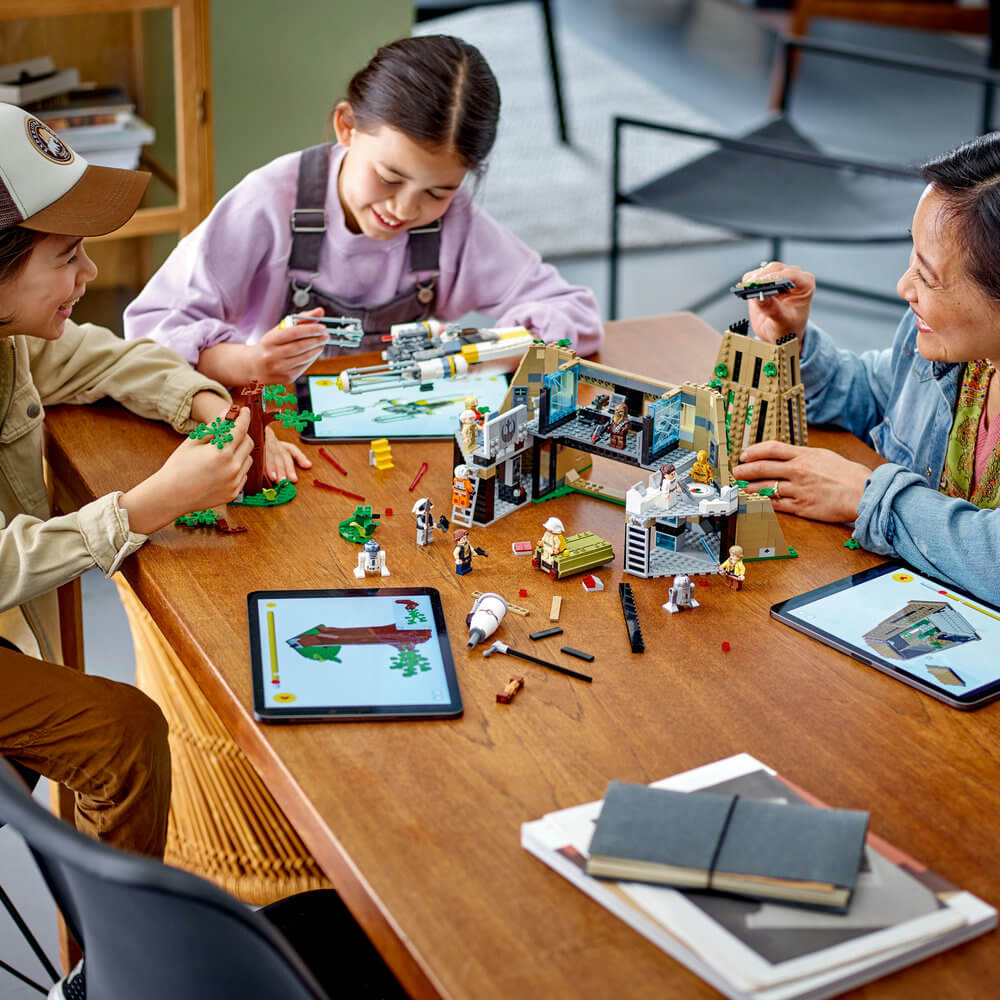 Three people shown building the LEGO® Star Wars™ Yavin 4 Rebel Base 75365 Building Toy Set (1,067 Pieces)