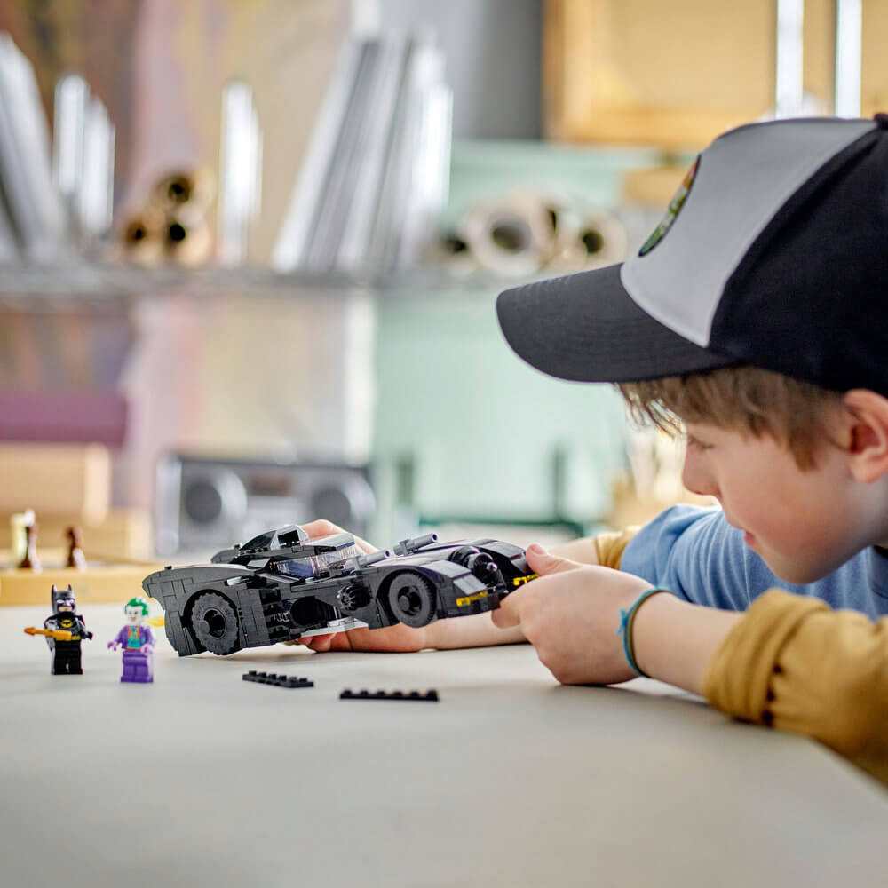 Boy playing with the LEGO® DC Batmobile™: Batman™ vs. The Joker™ Chase 76224 Building Toy Set (438 Pieces)
