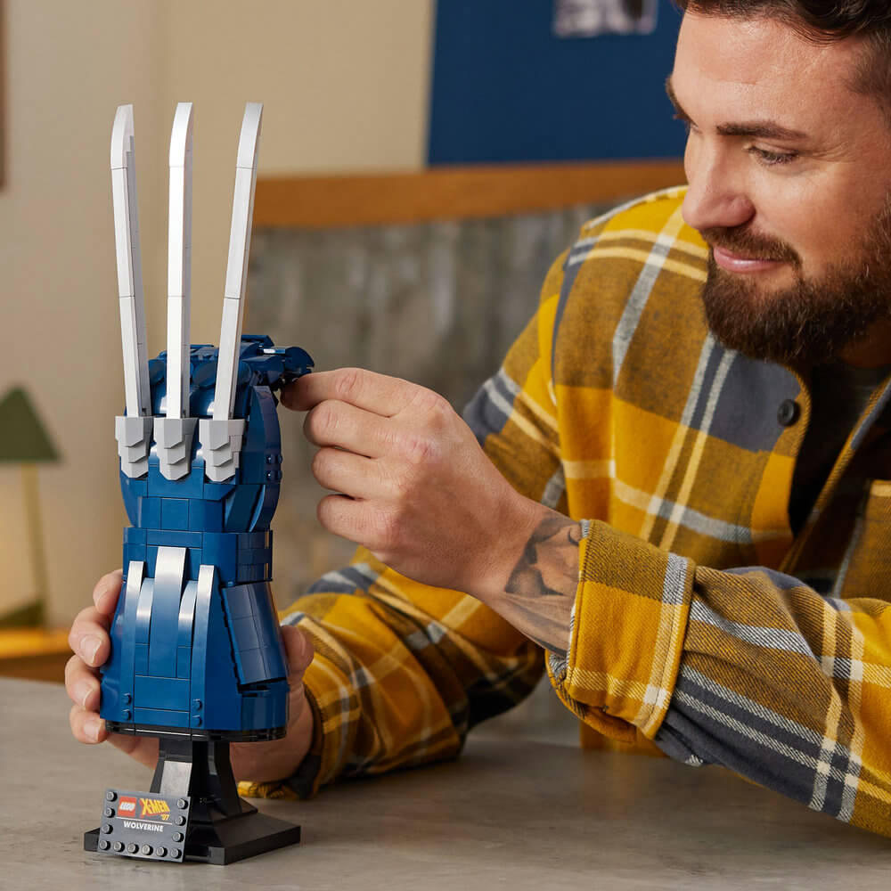 Man looking at the LEGO® Marvel Wolverine's Adamantium Claws 76250 Building Kit (596 Pieces)