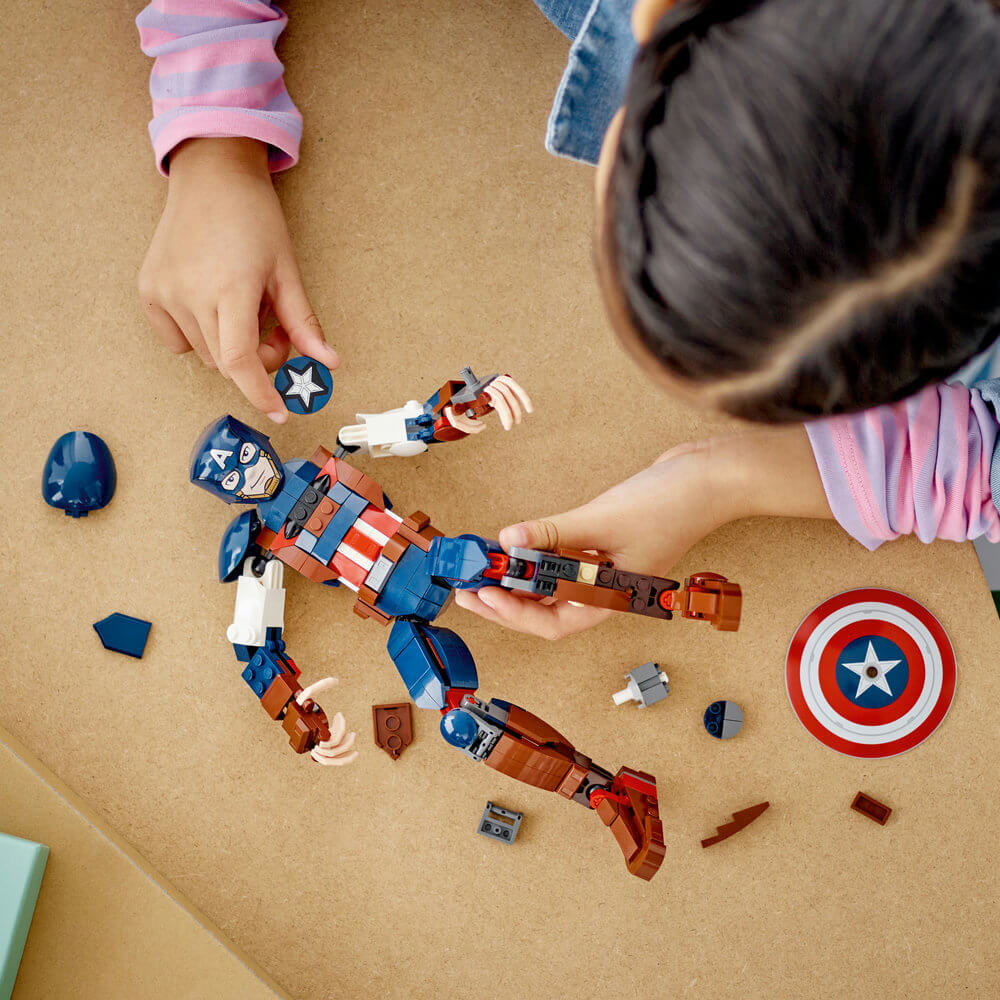Kid building the LEGO® Marvel Captain America Construction Figure 76258 Building Toy Set (310 Pieces)