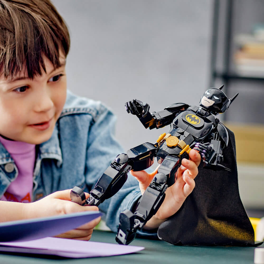 Kid playing with the LEGO® DC Batman™ Construction Figure 76259 Building Toy Set (275 Pieces)