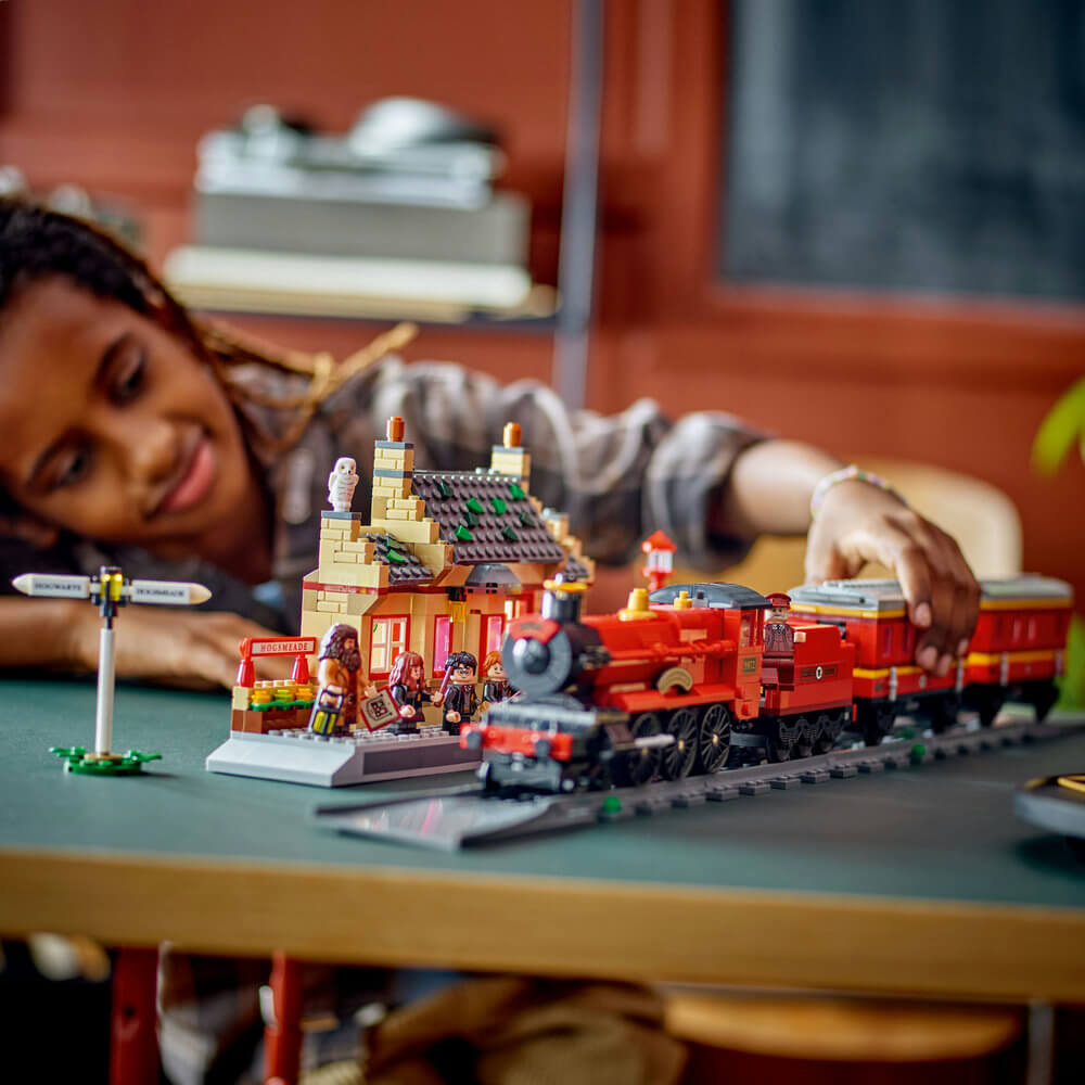 Child playing with the LEGO® Harry Potter™ Hogwarts Express™ & Hogsmeade™ Station 76423 (1,074 Pieces)