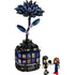 Fully assembled LEGO Wednesday Addams Black Dahlia Flower set displayed on white background, featuring two mini-doll figures, a tall stylized dark flower, and a gothic glass dome base marked "Nevermore Academy.