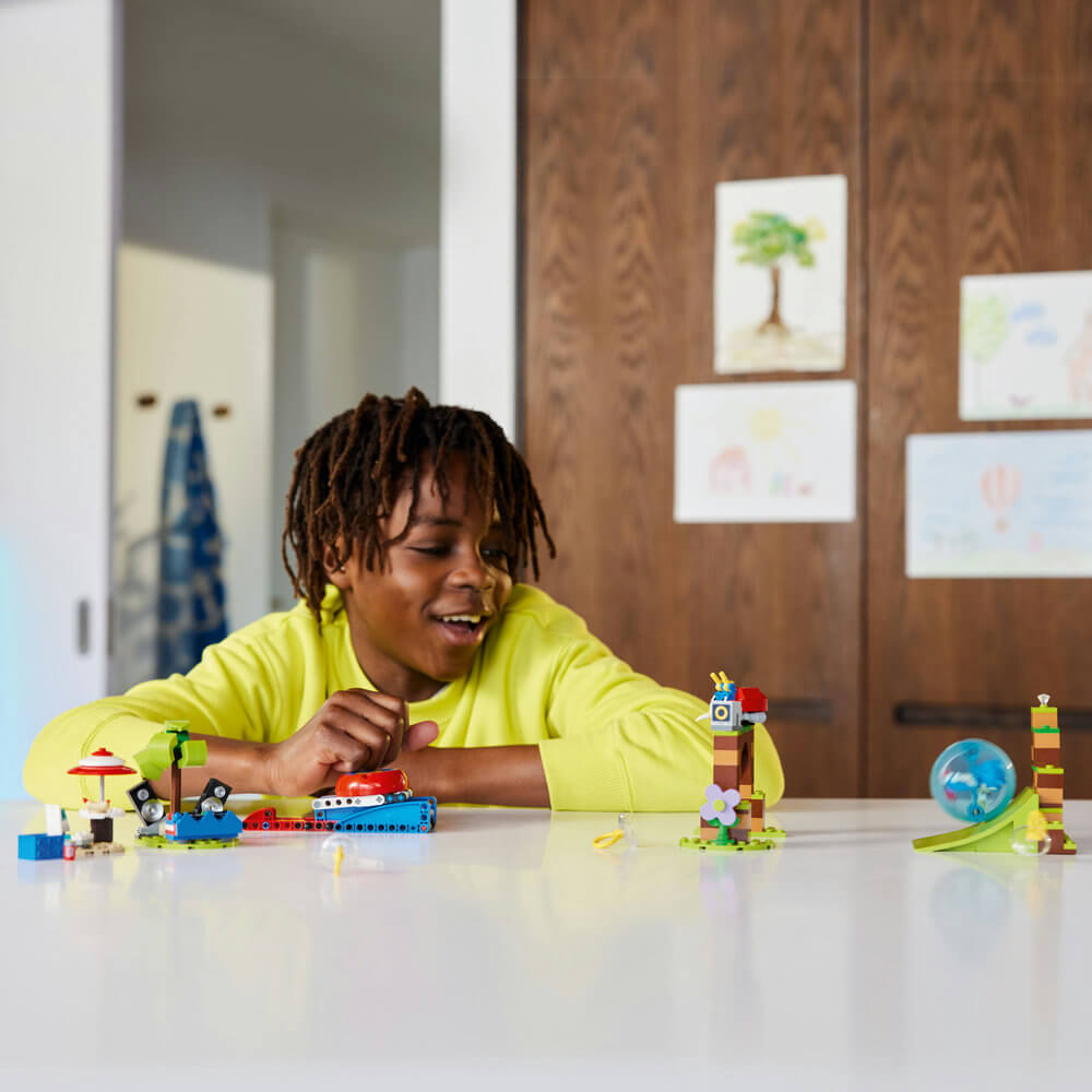 Child smiling as they play with the LEGO® Sonic the Hedgehog™ Sonic’s Speed Sphere Challenge 76990 Building Set (292 Pieces)