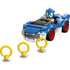 LEGO Sonic the Hedgehog Speedster Lightning car in bright blue and white plastic with smooth curved panels, low sporty shape, red wheels, and Sonic minifigure seated inside, shown with collectible gold rings on a white background.