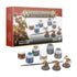 Warhammer Age of Sigmar Stormcast Eternals Paint Set includes gold plastic warrior miniatures, six Citadel Colour paint pots and a brush displayed beside red product packaging.
