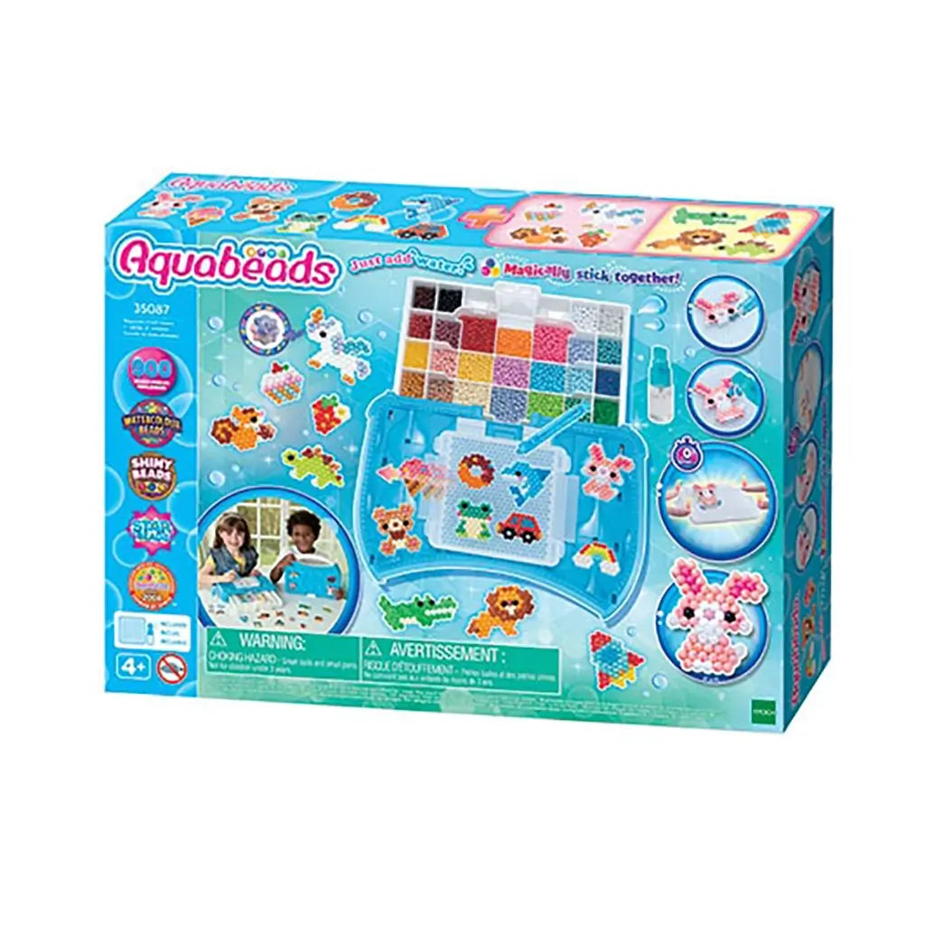 Aquabeads Beginners Craft Studio craft kit box with blue packaging showing bead tray, spray bottle, design templates, and sample creations made from multicolor water-activated beads.