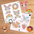 Aquabeads Beginners Craft Studio pattern sheets displaying printed bead placement guides for bunny, donut, rainbow, fox, and strawberry designs on a wooden tabletop.
