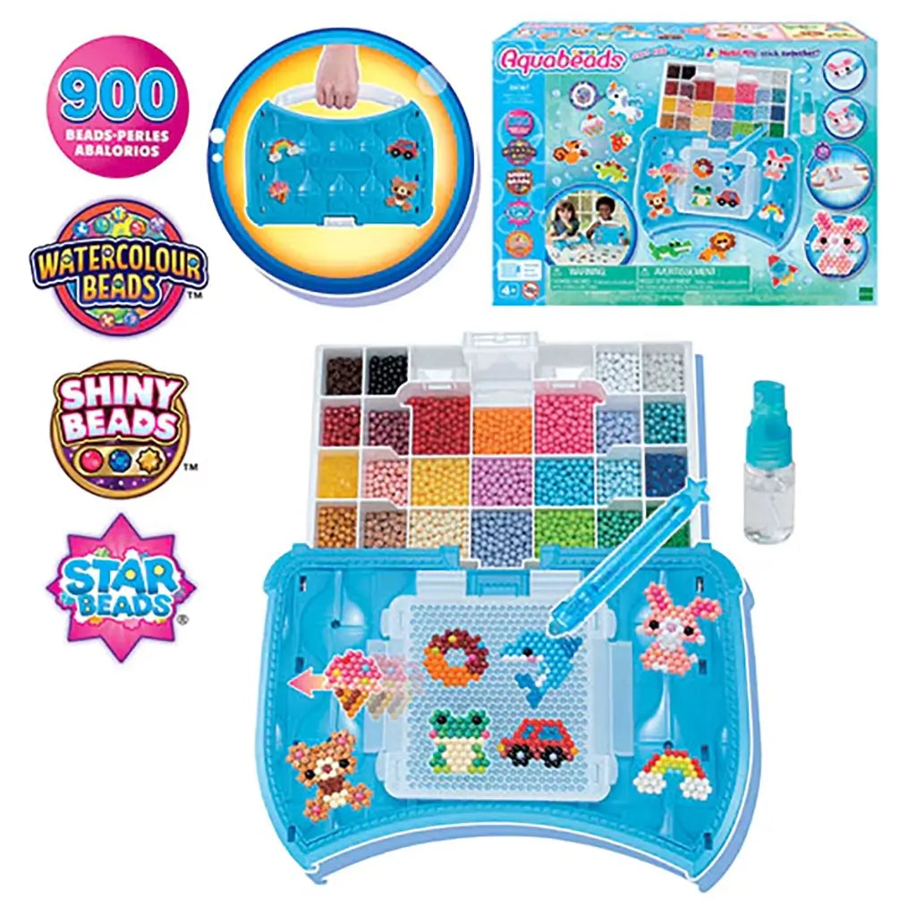 Aquabeads Beginners Craft Studio set with blue plastic storage case, bead palette tray, peg layout board, spray bottle, and assorted colorful water fuse beads arranged for crafting.