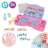 Aquabeads Design & Display Nail Studio playset featuring bow-shaped trays, water applicator, stickers, and 60 colorful nail decorations displayed on a pink and purple base.