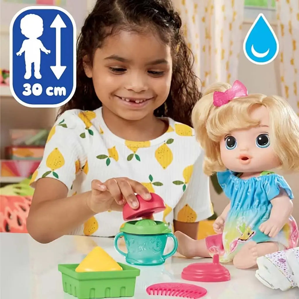 Child playing with Baby Alive Fruity Sips doll and pretend juicer, using green tray and teal cup, with measurement and water icons shown on a bright backdrop.