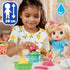 Child playing with Baby Alive Fruity Sips doll and pretend juicer, using green tray and teal cup, with measurement and water icons shown on a bright backdrop.