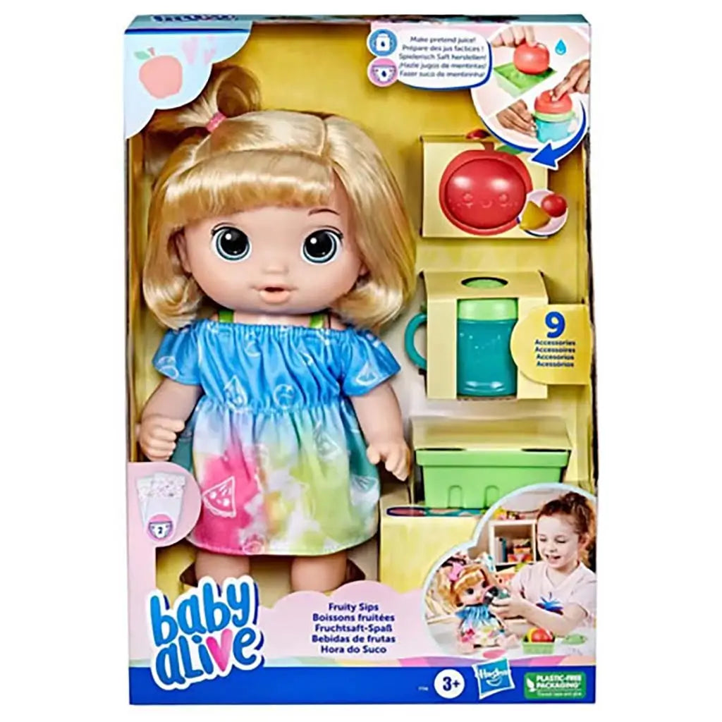 Baby Alive Fruity Sips boxed doll with blonde hair, tie-dye dress, fruit pieces, teal sippy cup, and accessories arranged in yellow open-window packaging.