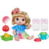Baby Alive Fruity Sips doll set with blonde doll in tie-dye dress, pink comb, pretend fruit, tray, teal sippy cup, and diapers arranged neatly on a clean white backdrop.